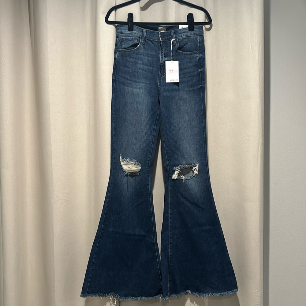 Brand new high rise Sneak Peek flair jeans.